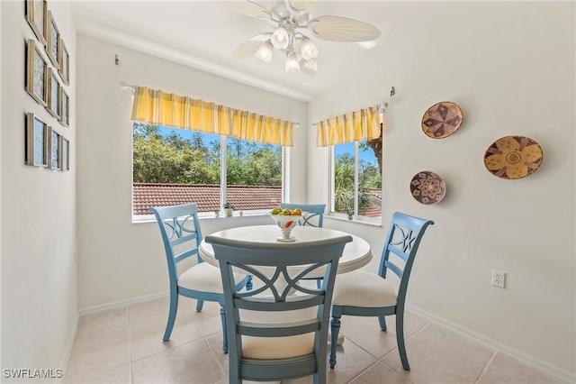 dining area with light tile patterned floors, ceiling fan, and baseboards