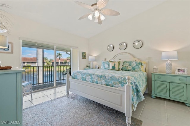 bedroom with a ceiling fan, a water view, access to outside, vaulted ceiling, and light tile patterned flooring