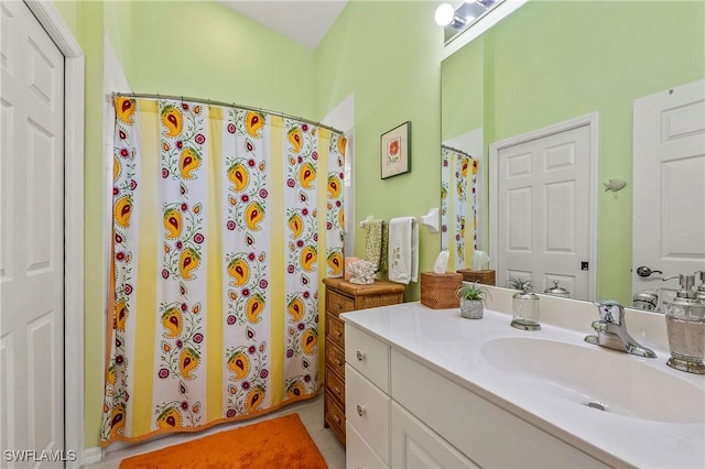 full bath with a shower with shower curtain and vanity