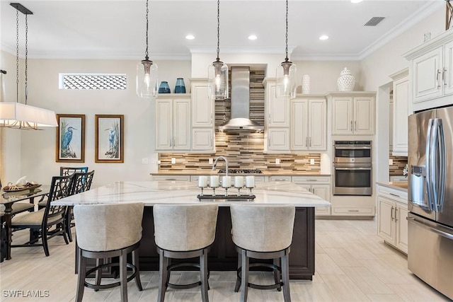 kitchen with appliances with stainless steel finishes, visible vents, ornamental molding, and wall chimney exhaust hood