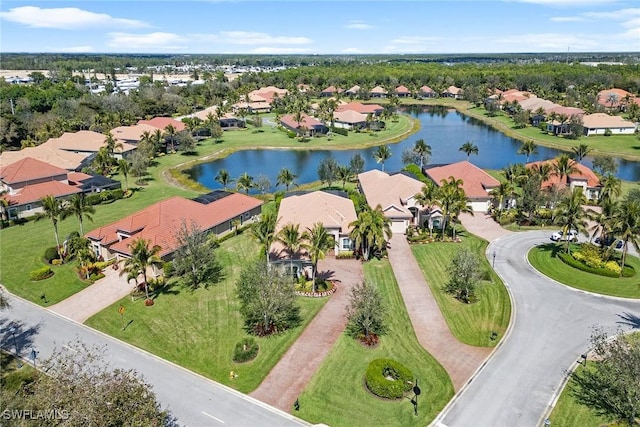 drone / aerial view featuring a residential view and a water view