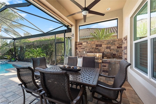 view of patio / terrace with glass enclosure, outdoor dining area, a sink, exterior kitchen, and grilling area