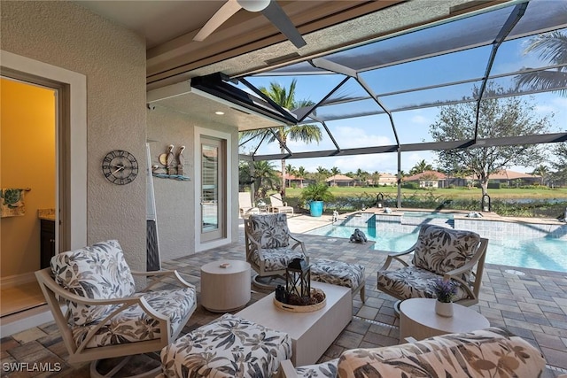 view of patio / terrace with glass enclosure, a ceiling fan, and an outdoor pool