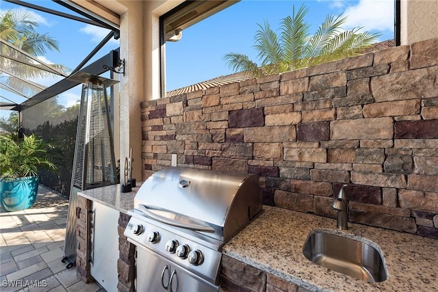 view of patio / terrace featuring a grill, a sink, and area for grilling