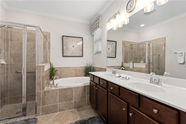 bathroom with tile patterned flooring, a sink, a shower stall, a bath, and crown molding