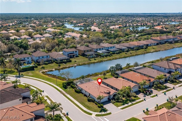 drone / aerial view featuring a residential view and a water view