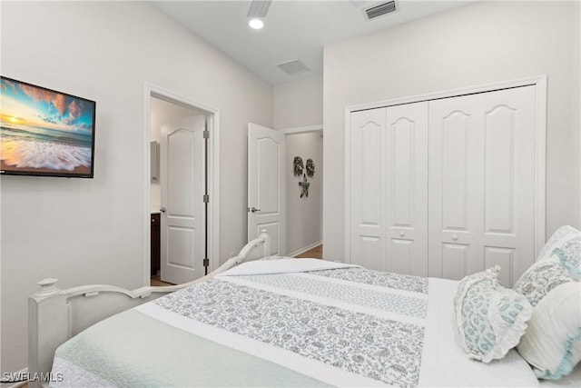 bedroom with a closet and visible vents