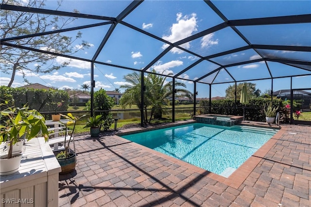 view of swimming pool featuring a patio, a lanai, and a pool with connected hot tub