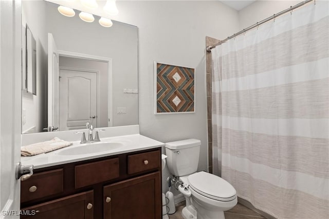 bathroom featuring toilet, a shower with shower curtain, tile patterned flooring, and vanity