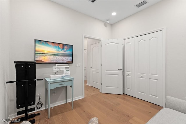 office space featuring light wood-style floors, baseboards, visible vents, and recessed lighting