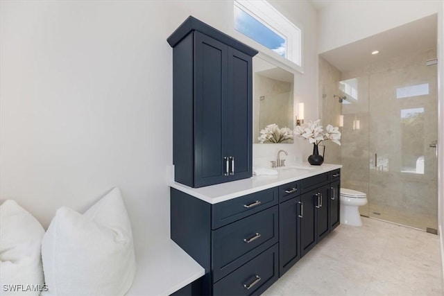 bathroom with toilet, a stall shower, and vanity