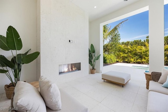 living room featuring a tile fireplace, recessed lighting, and tile patterned floors