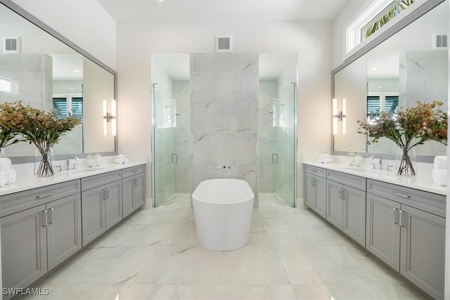 full bathroom featuring marble finish floor, a marble finish shower, and visible vents