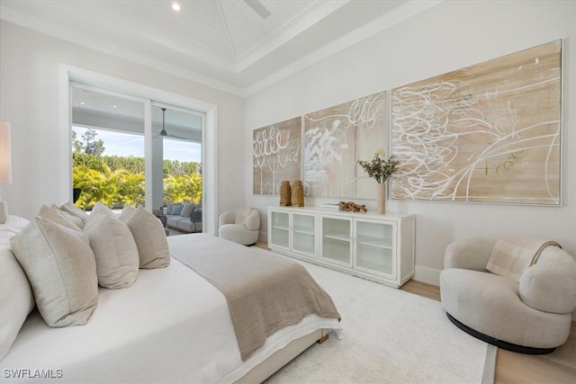 bedroom featuring wood finished floors, a ceiling fan, and crown molding