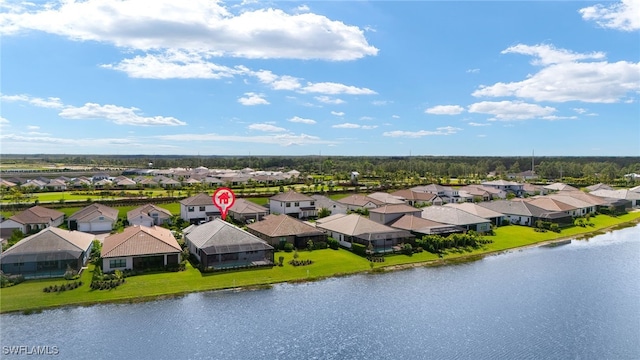 drone / aerial view featuring a water view and a residential view