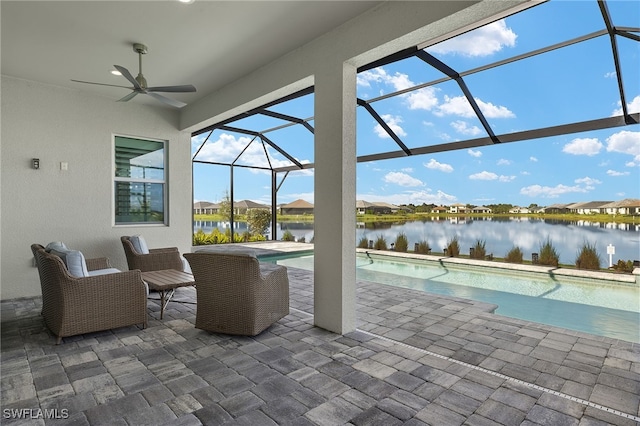 view of patio / terrace with a ceiling fan, glass enclosure, an outdoor pool, and a water view