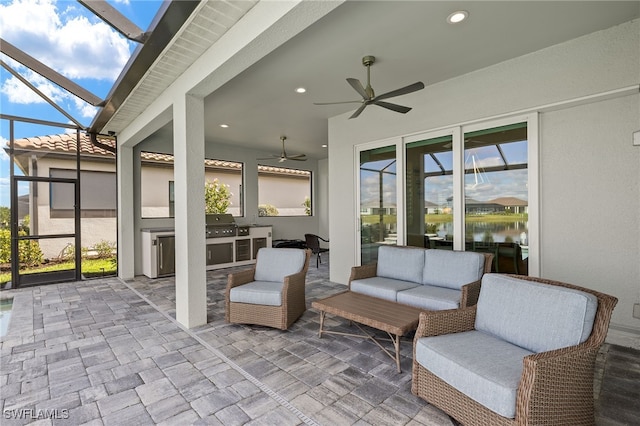 view of patio with glass enclosure, ceiling fan, area for grilling, and an outdoor hangout area