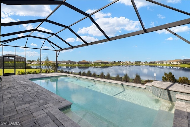 outdoor pool with a patio area, a lanai, and a water view