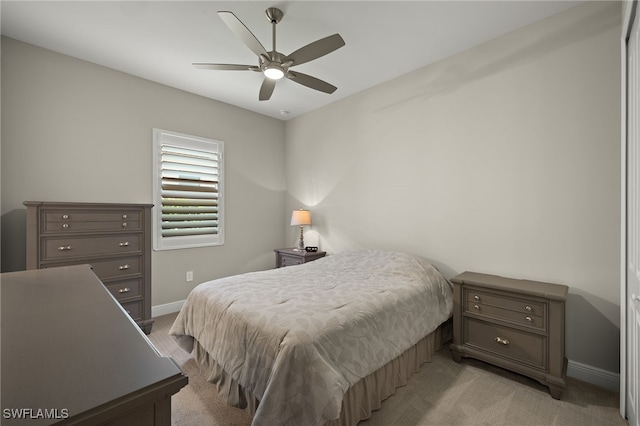 bedroom featuring ceiling fan, baseboards, and light colored carpet