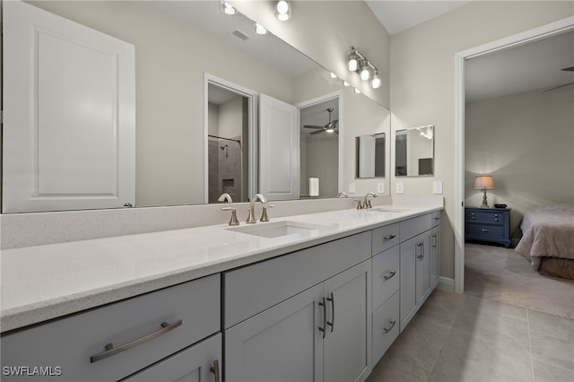 ensuite bathroom featuring double vanity, visible vents, a sink, and tile patterned floors