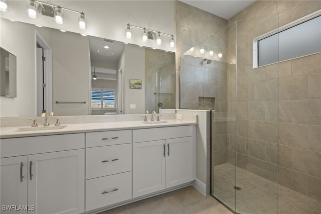 bathroom featuring tile patterned floors, double vanity, a sink, and walk in shower