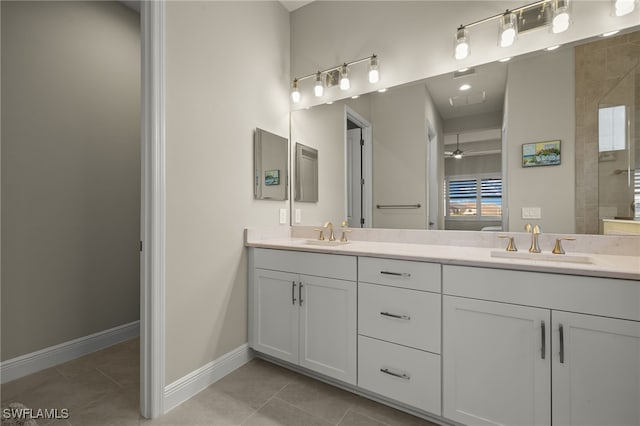 full bath featuring tile patterned flooring, a sink, baseboards, and double vanity