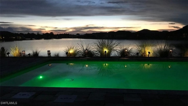 view of swimming pool featuring a water view