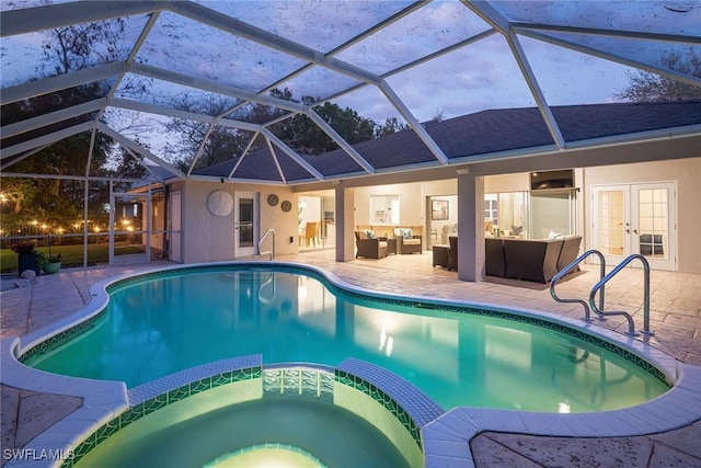 view of swimming pool featuring french doors, a patio area, a pool with connected hot tub, and an outdoor living space