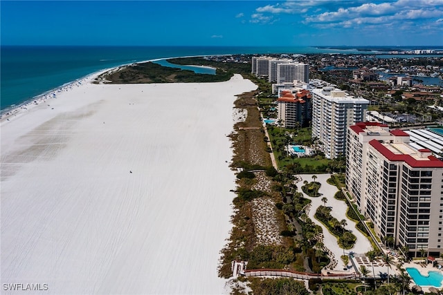 bird's eye view featuring a water view, a view of city, and a beach view