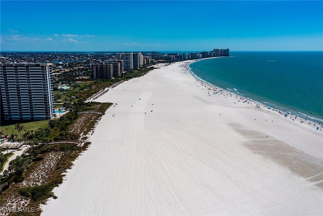 aerial view featuring a view of the beach, a water view, and a view of city