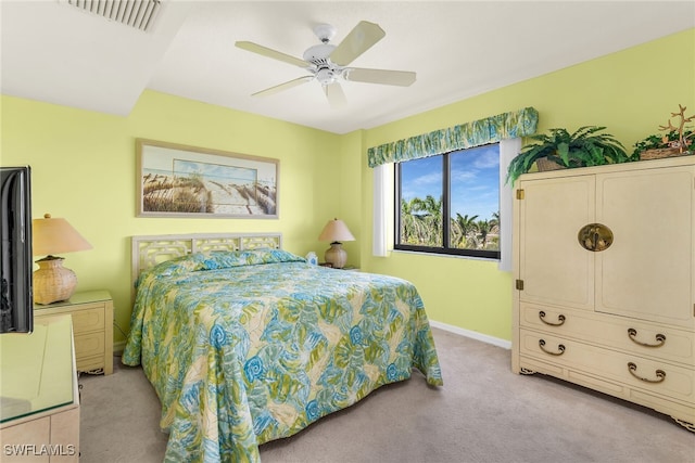 bedroom featuring baseboards, a ceiling fan, visible vents, and light colored carpet