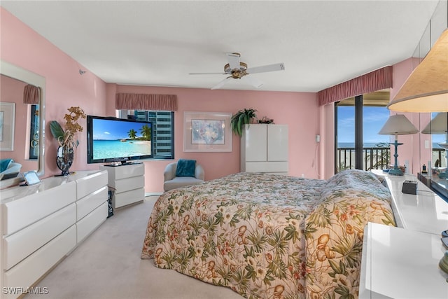 bedroom with access to outside, carpet, and a ceiling fan