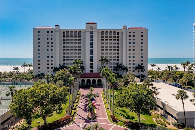 view of property featuring a beach view and a water view