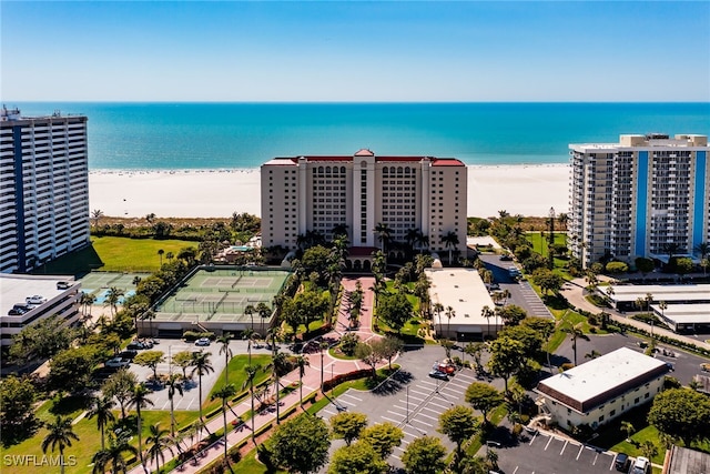 drone / aerial view featuring a water view and a beach view