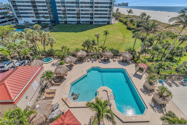 community pool featuring a patio area and a water view