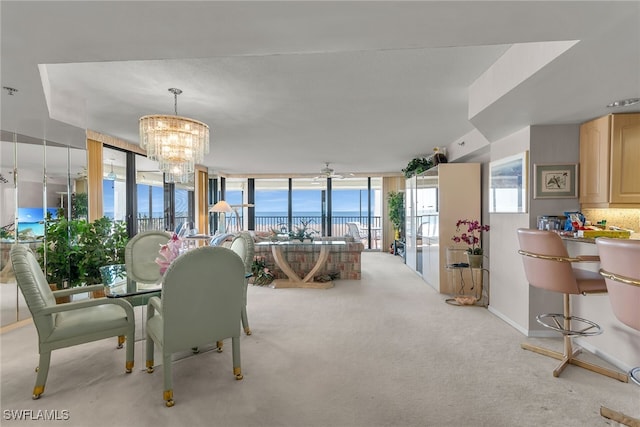 carpeted dining space featuring baseboards, a wall of windows, and a notable chandelier