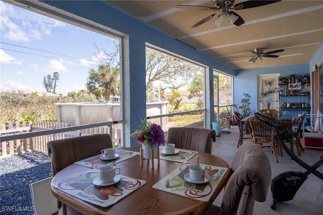 sunroom / solarium featuring a wealth of natural light and a ceiling fan