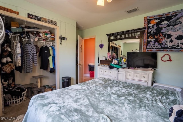 bedroom featuring carpet floors, visible vents, and a closet