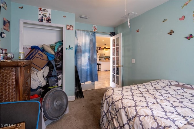 carpeted bedroom featuring visible vents