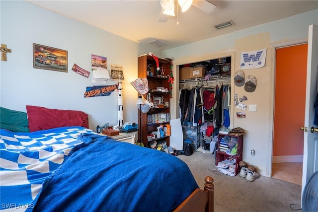 carpeted bedroom with ceiling fan, a closet, visible vents, and baseboards