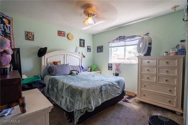 bedroom with a ceiling fan and dark carpet