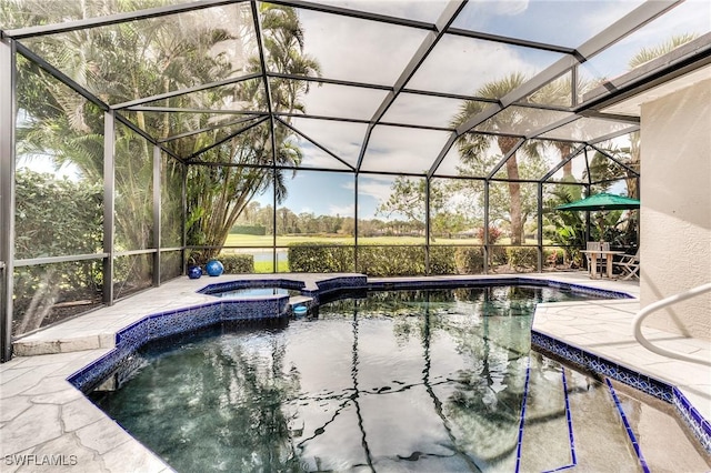 view of pool featuring a patio, a lanai, and a pool with connected hot tub