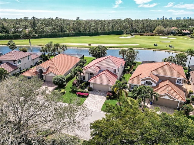 drone / aerial view with a water view and golf course view