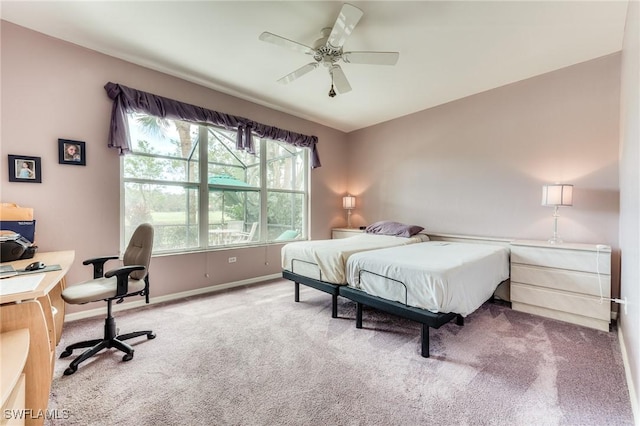 carpeted bedroom featuring a ceiling fan and baseboards