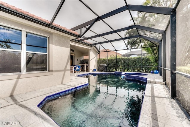 view of swimming pool with a pool with connected hot tub, a patio area, and a lanai