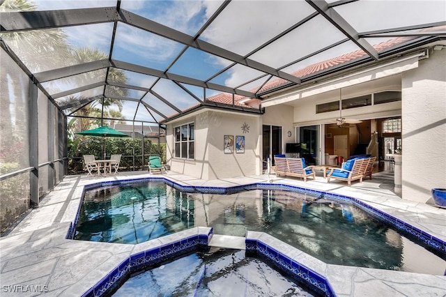 view of pool with a patio area, a pool with connected hot tub, an outdoor hangout area, and ceiling fan