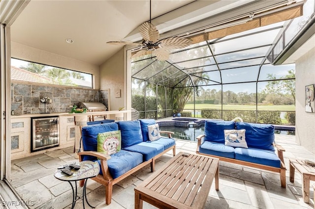 sunroom with vaulted ceiling, wine cooler, plenty of natural light, and a ceiling fan