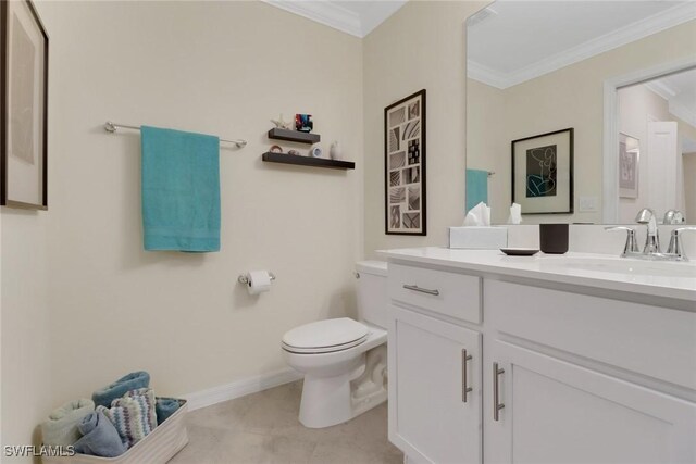 bathroom with ornamental molding, vanity, toilet, and tile patterned floors