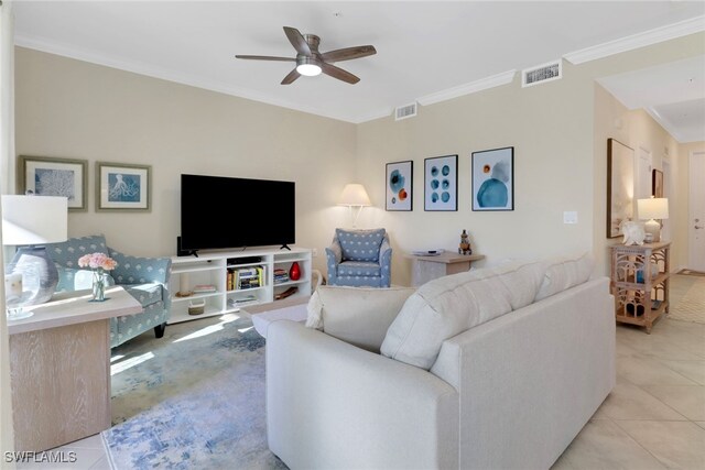 living area featuring light tile patterned floors, ceiling fan, visible vents, and crown molding