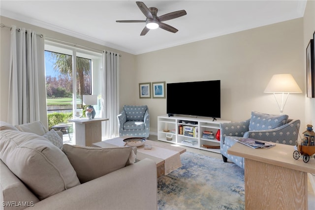 living room featuring ceiling fan and crown molding